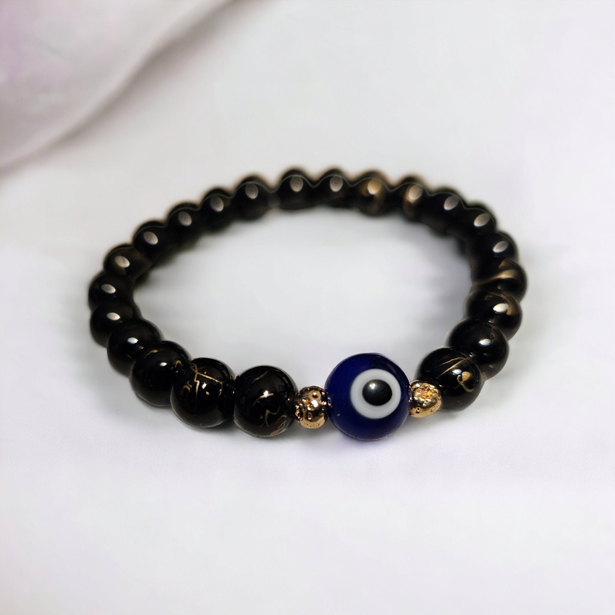 Evil Eye Protection Bracelet: Glass Beads & Gold Hematite Accent Beads in Gold Tone